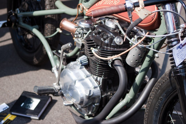 Mehrere Motorräder auf einem Parkplatz mit einem Buch in der Nähe liegend.
