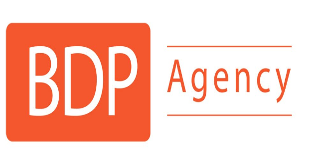 Das Logo der Agentur bdp zeigt die Worte 'bdp agency' in fetter schwarzer Schrift, umgeben von einem blauen und weißen Kreis, alles auf einem weißen Hintergrund.