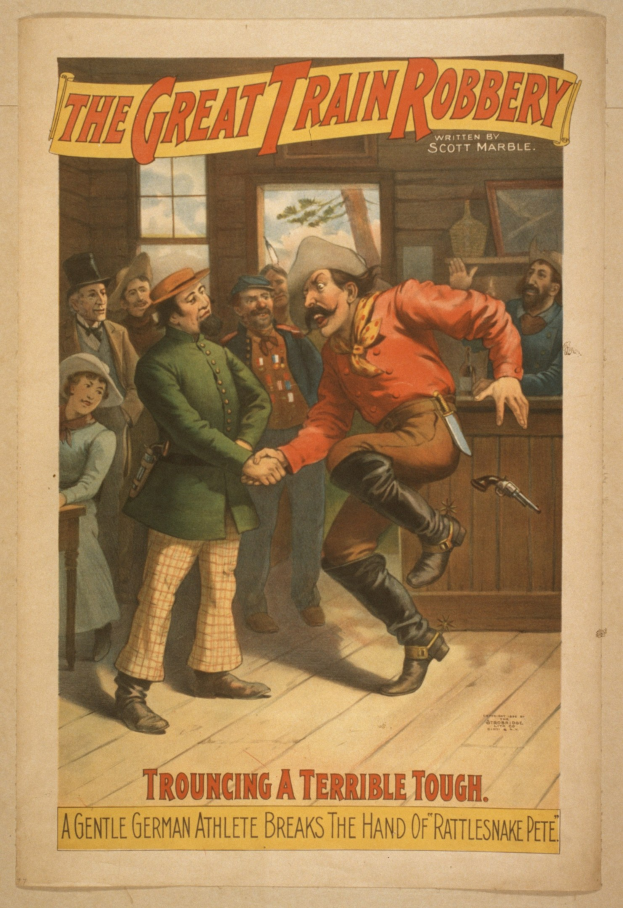 Plakat zeigt eine Gruppe von Menschen auf einem Boden mit einem, der eine Waffe hält, ein Fenster und eine Wand im Hintergrund und den Text "Die große Zugüberfall - Trouching a Terrible Tough" oben und unten.